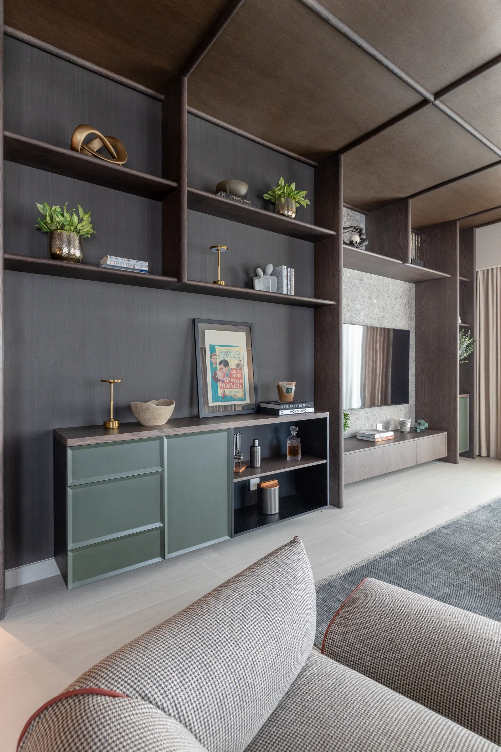 Twyst Interiors.Berkeley Place evening living room with built-in joinery, sage-green cabinet, layered shelving.