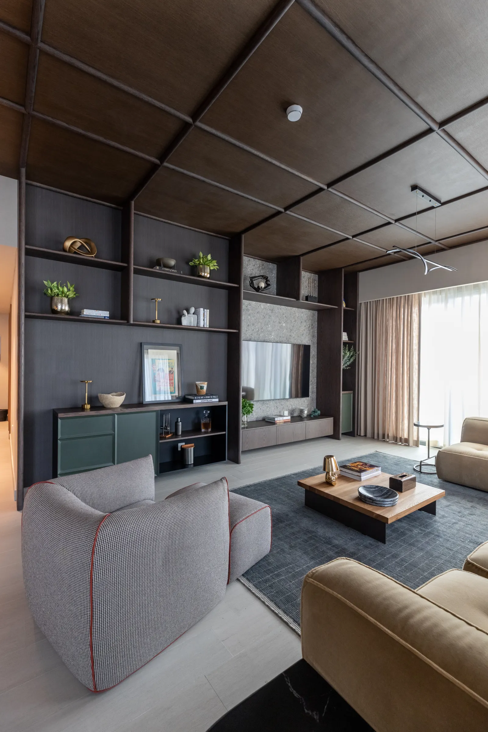 Twyst Interiors.Berkeley Place evening living room with built-in joinery, sage-green cabinet, layered shelving.